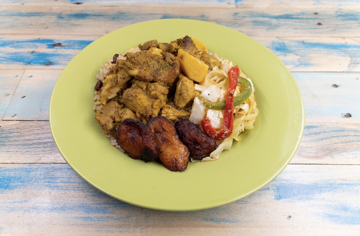 The Rollin Pitt curry chicken plate with rice and peas, cabbage and plantains