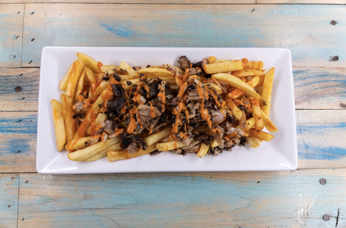 Loaded fries topped with seasoned meat and sauce